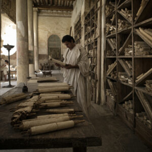 Library of Alexandria ancient scrolls and towering columns in a dramatic reconstruction of the lost scholarly center